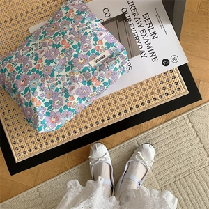 Close-up of a floral cotton makeup bag in purple, featuring a Sozakka brand tag