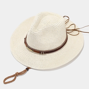 Chic cream western straw cowboy hat with feather trim and adjustable chin strap
