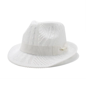 White openwork knit sun hat with satin ribbon and bow for summer beach vacation