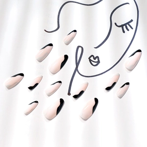 Elegant nude and black wave pattern press-on coffin nails displayed on a minimalist background