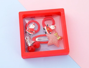 Christmas hair accessory set including Santa ties and glitter clips in a red display box