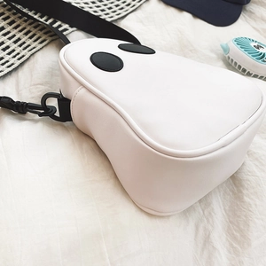 Detail of creative ghost-shaped white PU leather crossbody bag with black adjustable strap