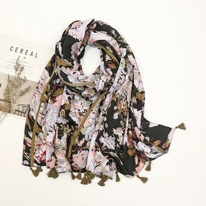 Detail of floral printed scarf with olive green tassels and vintage porcelain style pattern