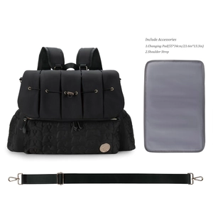 Detailed view of diaper bag accessories including a changing pad and shoulder strap