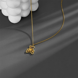 Polished 18k gold plated bear pendant necklace with bow tie and dark textured details
