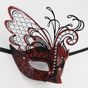 Detail of masquerade butterfly mask with red glitter patterns and rhinestone accents