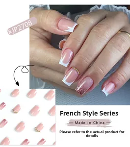 Detailed view of French pink press-on nails with white tips and glitter accents