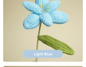 Macro shot of handcrafted light blue crochet tulip with green leaves and yellow pistils