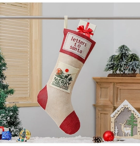 Beige linen Christmas stocking featuring Letters to Santa pocket hanging on fireplace