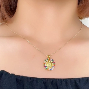Detailed shot of Virgin Mary pendant with colorful cubic zirconia on a gold chain