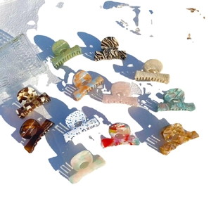 Assorted acetate hair claws with marble and tortoiseshell patterns for elegant styling