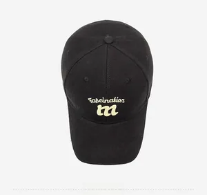 Top view of black corduroy baseball cap featuring yellow Fascination letter embroidery