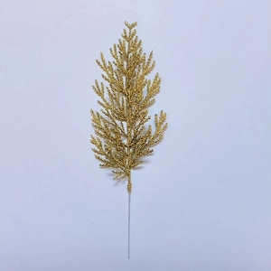 Detailed close-up of golden artificial pine branches with sparkling glitter coating
