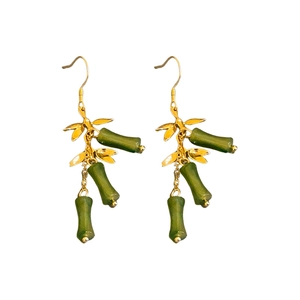 Bamboo style gold tassel earrings with green bamboo nodes and hanging leaves on white background