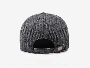 Detail view of winter baseball cap back with metal buckle and wool blend check texture