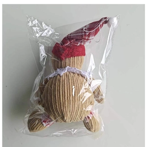 Detailed view of gingerbread man plush ornament in corduroy with a red knitted hat