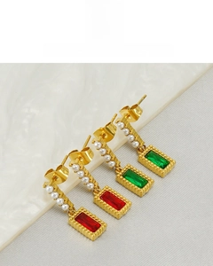 Close-up of 18K gold plated rectangular earrings with red and green stones and pearls