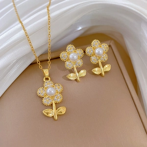 Detailed view of floral titanium jewelry set with pearls and diamonds on silk