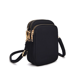 Black nylon mini crossbody phone bag with three zipper compartments and gold hardware