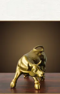 Detailed view of the charging golden bull statue with a matte satin metallic finish