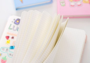 Macro detail of high-quality grid inner pages with soft cream-colored eye-care paper texture