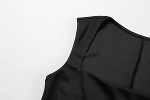 Close-up of square neckline and fine texture on a sleek black summer dress