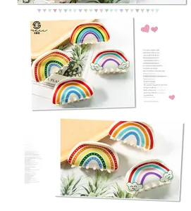 Detailed view of rainbow patterned hair claws with colorful stripes and polka dots
