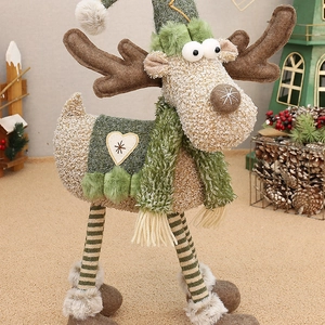 Standing Christmas reindeer decoration with knit legs and plush scarf on cozy background