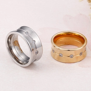 Pair of 10mm gold and silver titanium steel rings with inlaid zircon stones