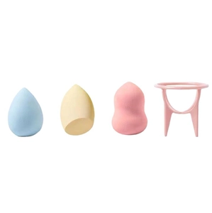 Three colorful makeup sponges in different shapes with a pink drying stand for cosmetics