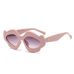 Pink irregular wavy sunglasses with purple gradient lenses and gold petal metal accents