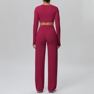 Detail of burgundy high-waist wide-leg pants and slim fit long sleeve crop top yoga set