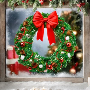 Close-up of a Christmas wreath with pine cones and red bow on a frosted window frame