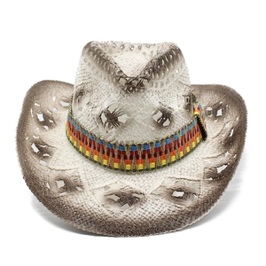 Straw western cowboy hat with hollow weave and colorful ethnic band on white background