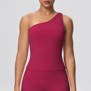 Detail of berry red one-shoulder sports bra showing soft brushed fabric and sleek seams