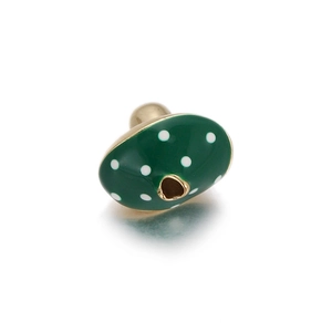Macro shot of green enamel spacer bead with white polka dots and gold edges for DIY jewelry
