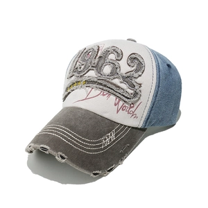 Detailed close-up of vintage distressed 1962 embroidery and stitching on baseball cap