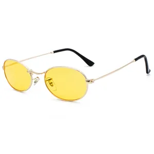 Retro small oval sunglasses with thin gold metal frame and yellow transparent lenses