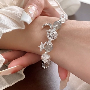 Star and moon charm bracelet with clear crackle crystals and silver star moon pendants