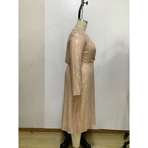 Detailed side view of champagne sequin dress with long sleeves and slim-fit waist design