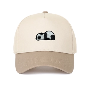 Close-up of a two-tone baseball cap with a sleeping panda embroidery on a beige crown