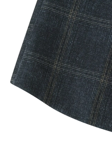 Macro close-up of dark grey plaid tweed fabric texture for women's blazer jacket