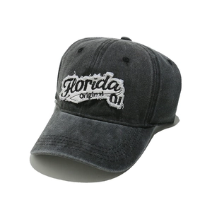 Detailed close-up of vintage washed denim baseball cap with Florida embroidery