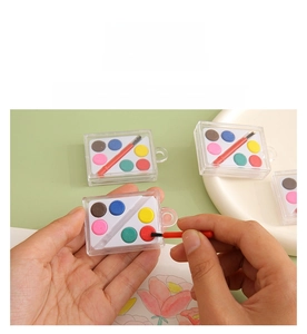Detail of portable 6-color solid watercolor paint set with mini brush and transparent case