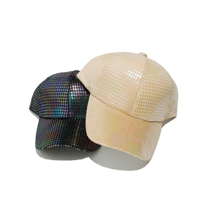 Detail of shimmering sequin houndstooth texture on stylish baseball caps for women