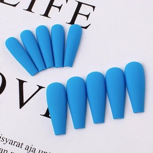 Detail view of matte royal blue coffin press-on nails with a frosted texture finish