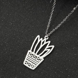 Macro shot of silver cactus pendant necklace showing detailed geometric laser cut pattern