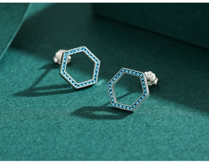 Macro view of S925 sterling silver hexagonal stud earrings with blue turquoise inlay
