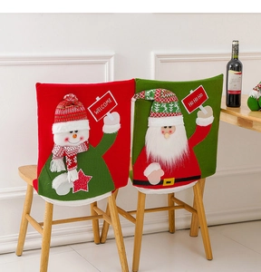 Detail view of festive red snowman and green Santa chair covers in a dining room setting