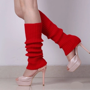 Close-up of bright red ribbed knit leg warmers with textured fabric details